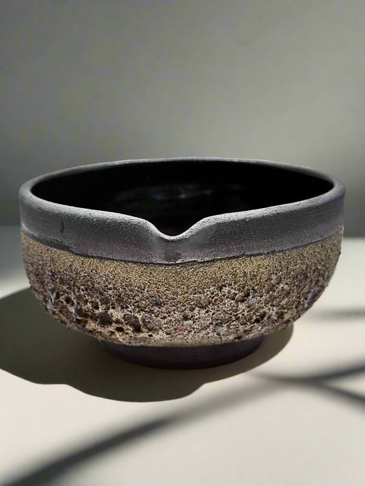 Ceramic bowl with textured surface on a white background